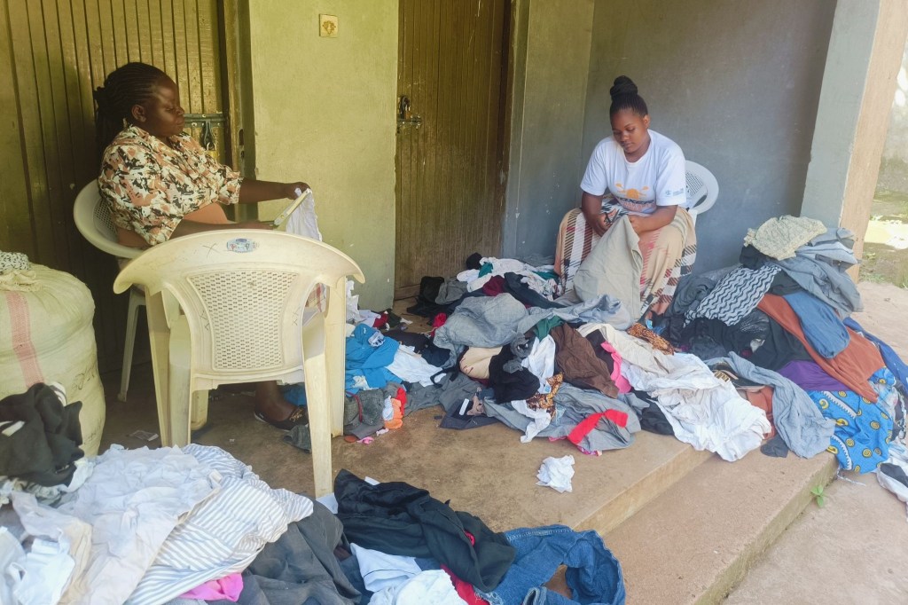 Two workers cutting up cotton textile waste - Can Farming Reduce Global Textile Waste?